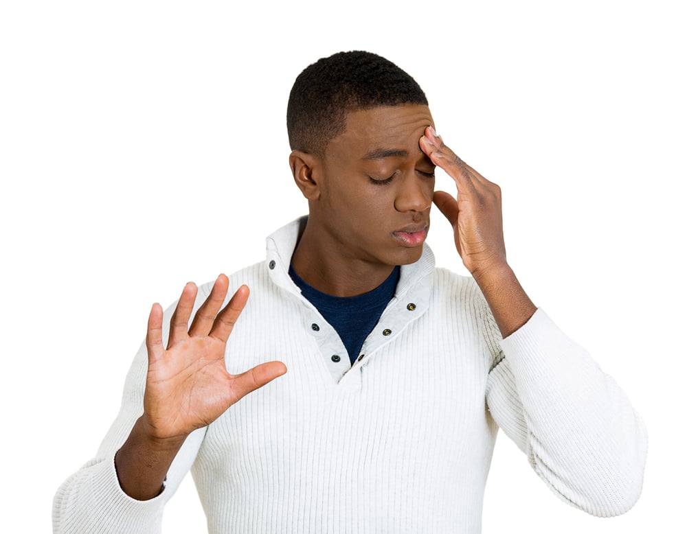 Closeup portrait, young, frustrated man with bad attitude giving talk to hand with palm outward, hand on head, isolated white background. Negative emotions, facial expression feelings, body language