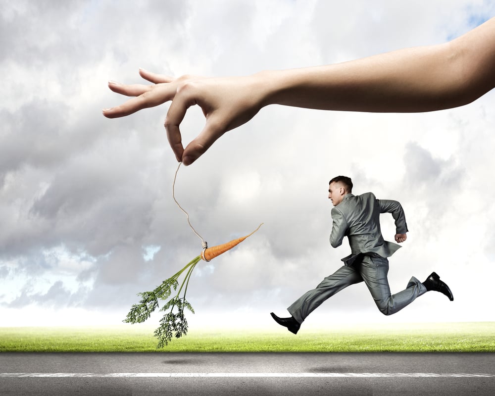 Funny image of businessman chased with carrot