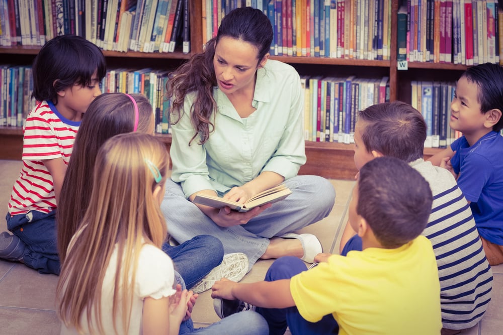 Teacher reading her pupils a story at the elementary school