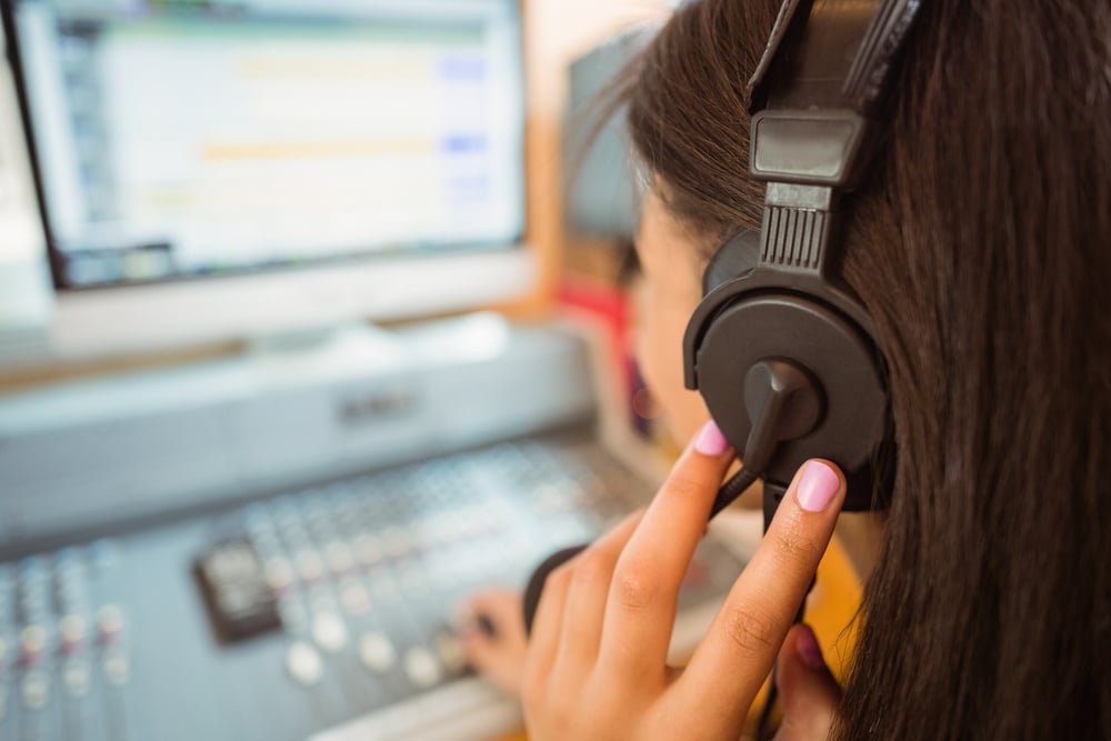 University student mixing audio in a studio of a radio
